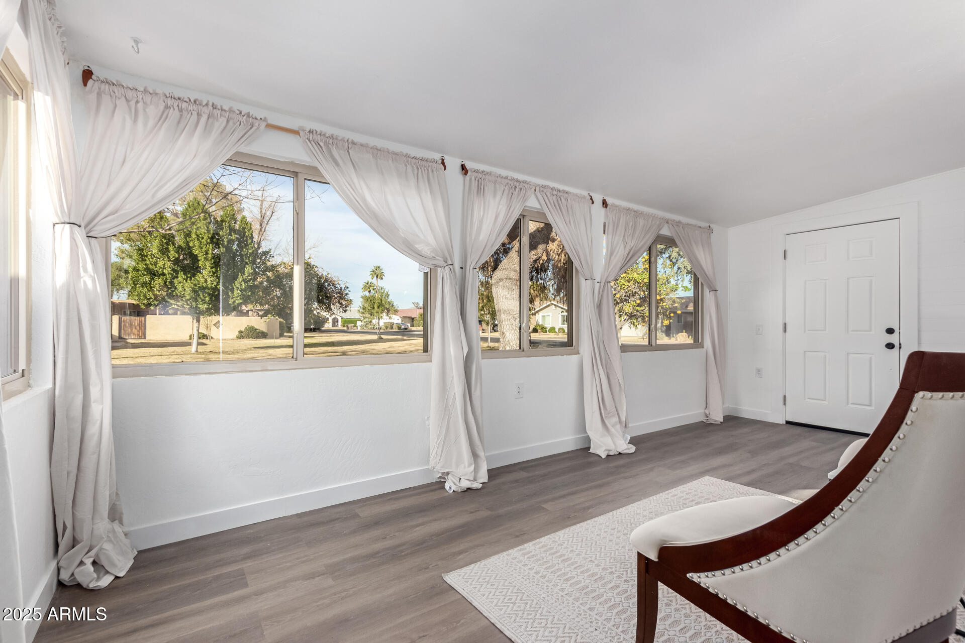628 Leisure World Mesa, AZ 85206 - Photo 11 of 51 a view of an empty room with window and wooden floor