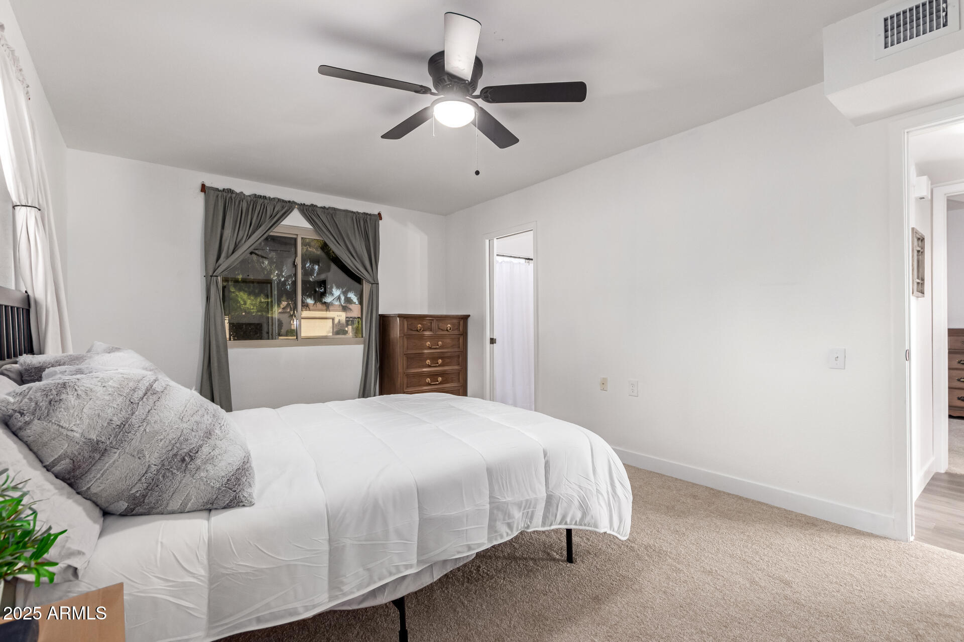 628 Leisure World Mesa, AZ 85206 - Photo 15 of 51 a bedroom with a large bed and a chandelier