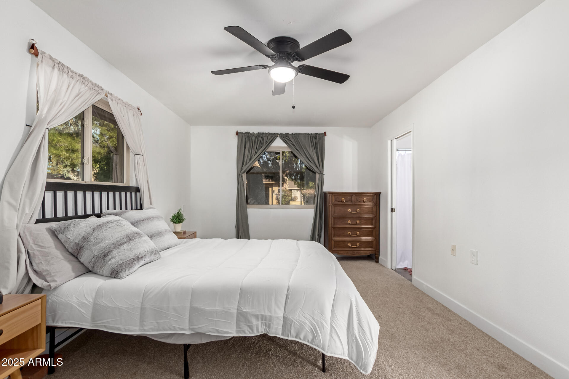 628 Leisure World Mesa, AZ 85206 - Photo 16 of 51 a bedroom with a bed and a ceiling fan