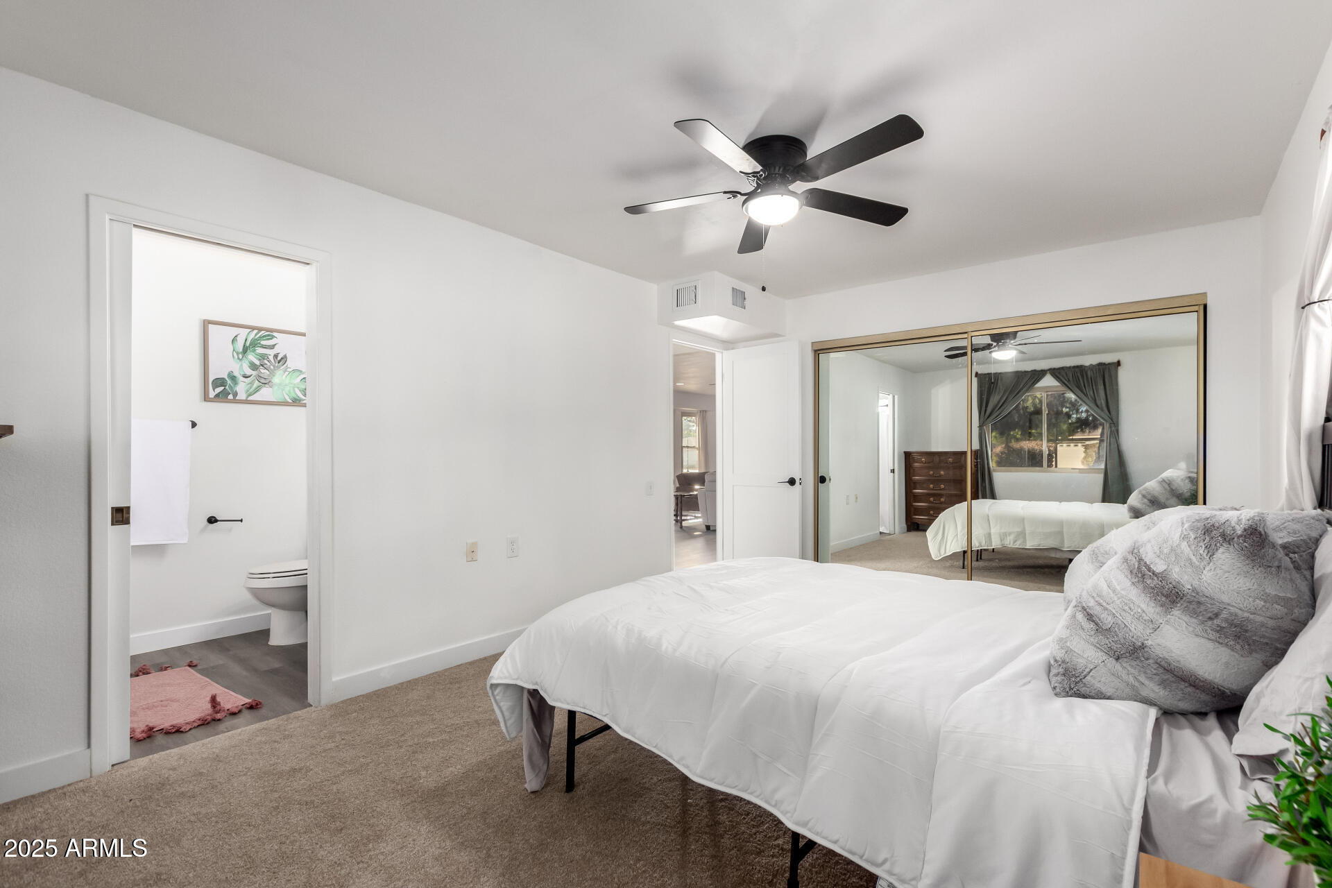 628 Leisure World Mesa, AZ 85206 - Photo 18 of 51 a bedroom with a bed and a chandelier