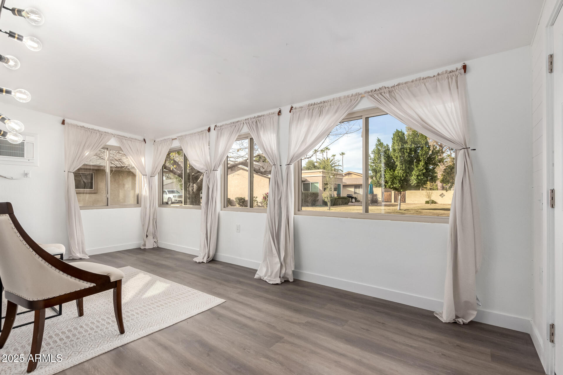 628 Leisure World Mesa, AZ 85206 - Photo 8 of 51 a view of an empty room with wooden floor and a window