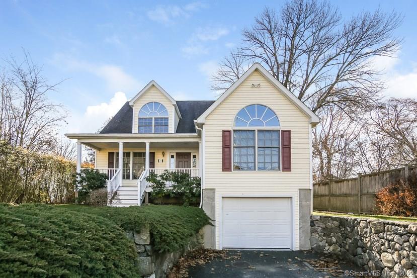 27 Meadow Drive Greenwich, CT 06807 - Photo 1 of 1 a front view of a house with a yard and trees