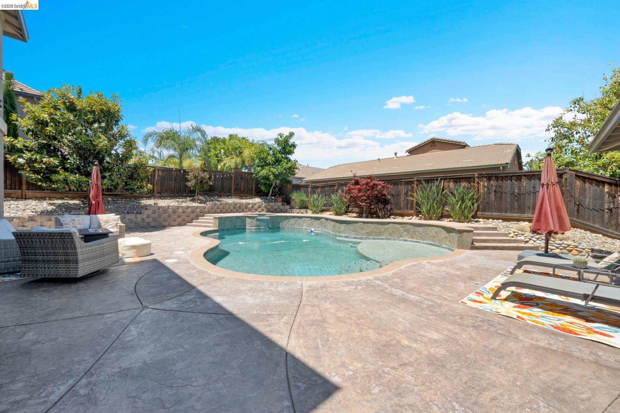 2513 Winged Foot Road Brentwood, CA 94513 - Photo 33 of 45 Curved swimming pool with integrated spa and stone surround