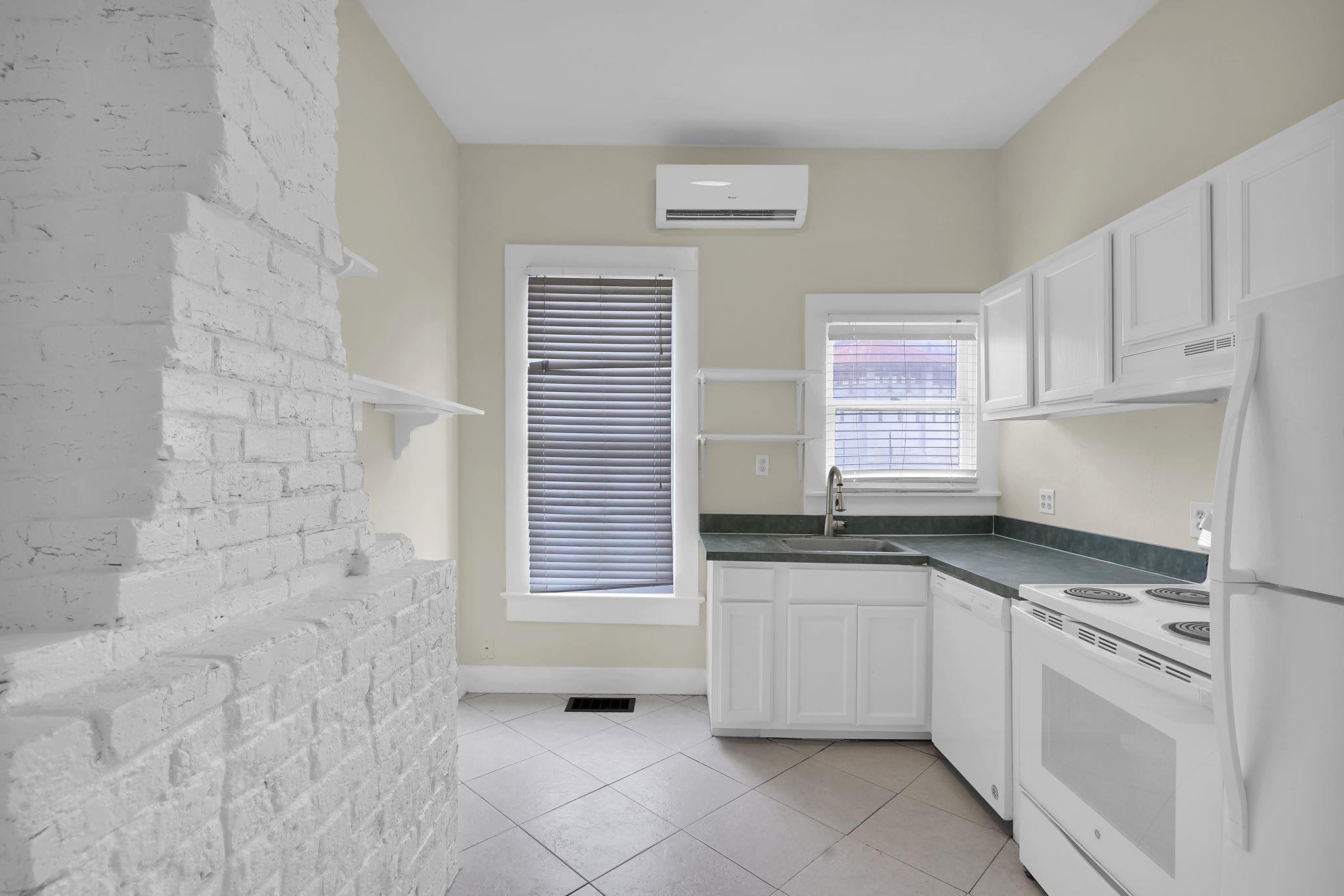 75 Cedar Street St. Augustine, FL 32084 - Photo 12 of 56 a kitchen with granite countertop white cabinets and white appliances