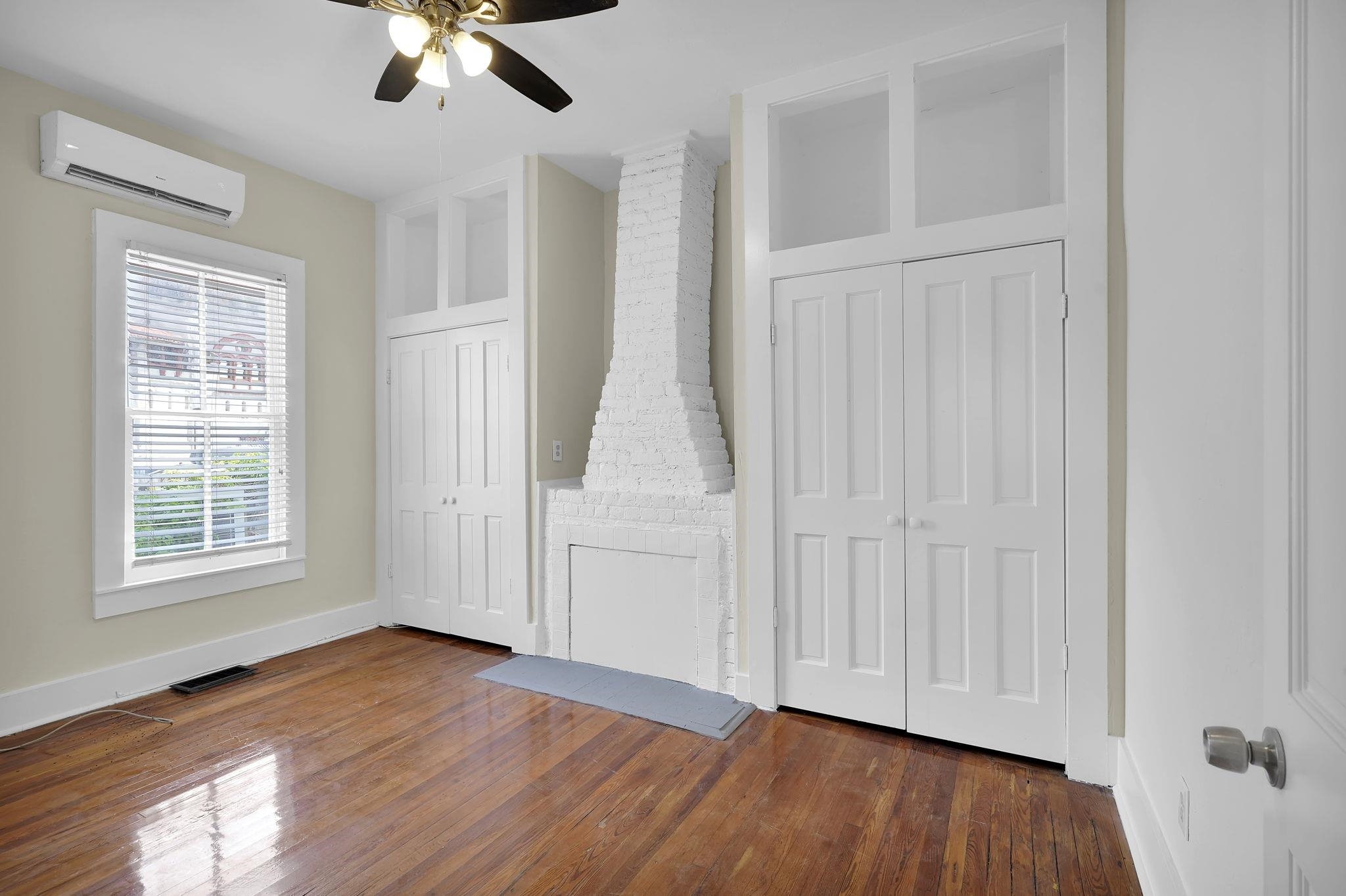 75 Cedar Street St. Augustine, FL 32084 - Photo 21 of 56 an empty room with wooden floor chandelier fan and windows