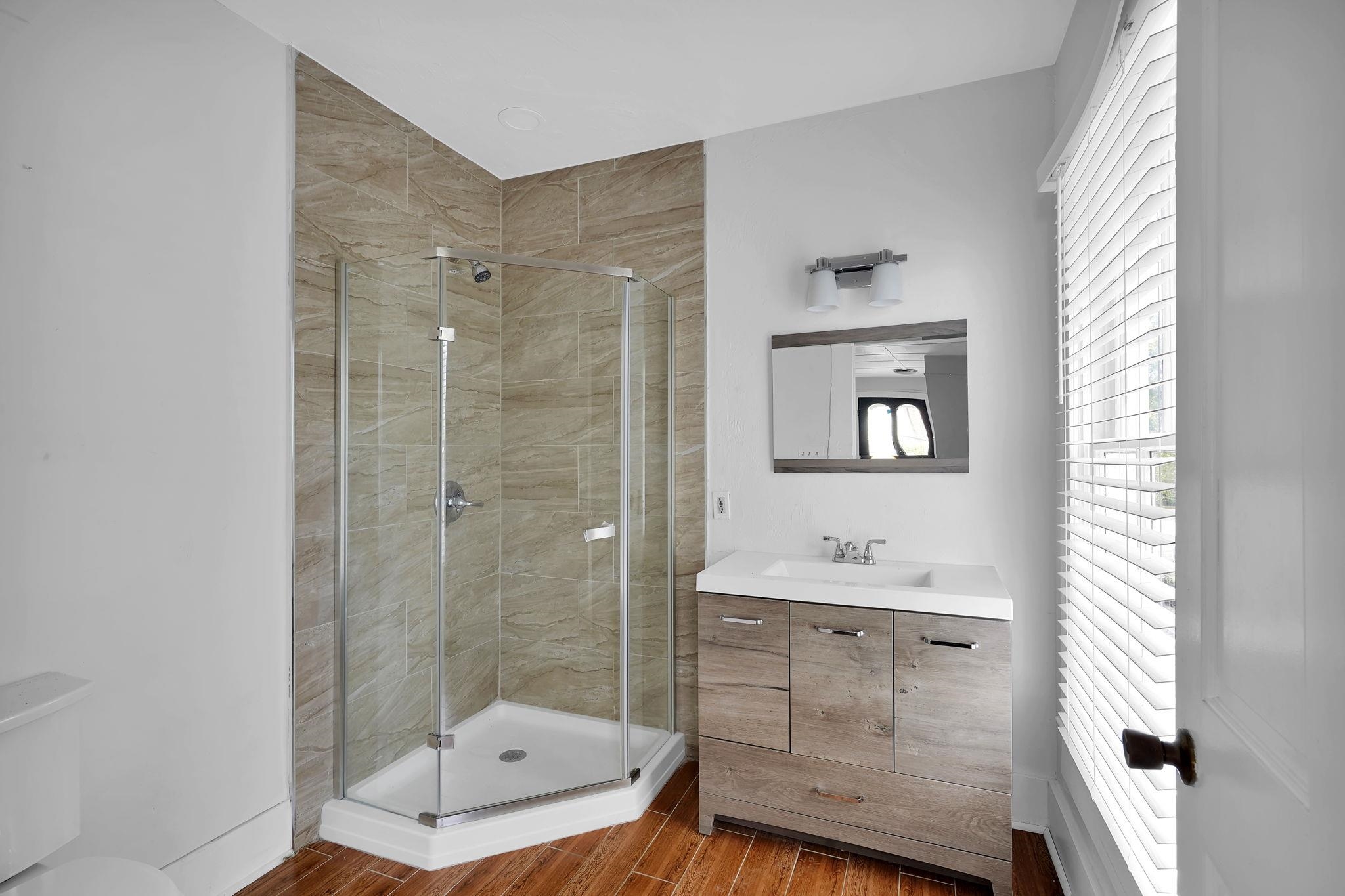 75 Cedar Street St. Augustine, FL 32084 - Photo 24 of 56 a bathroom with a shower sink and mirror