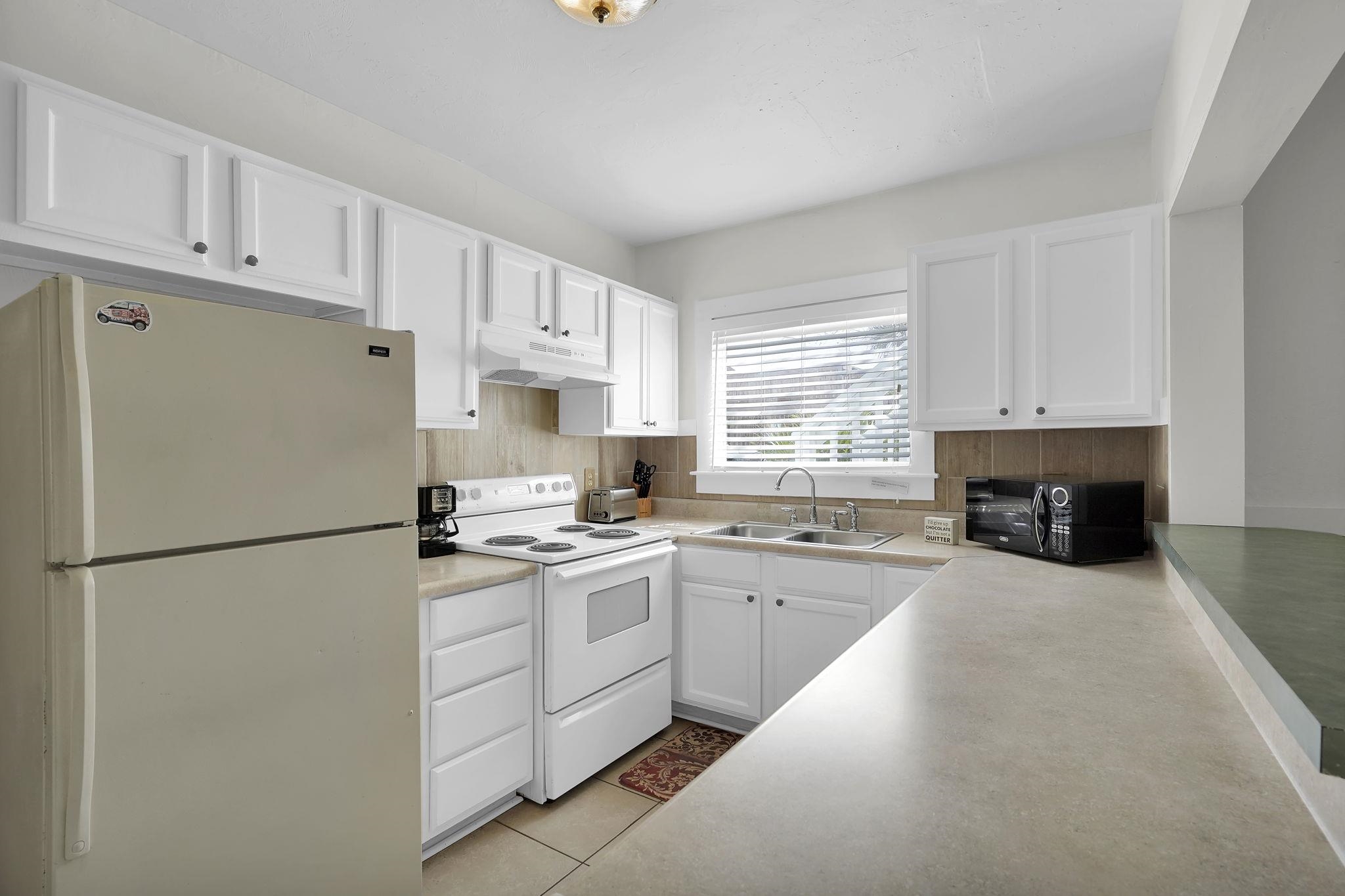 75 Cedar Street St. Augustine, FL 32084 - Photo 45 of 56 a kitchen with cabinets appliances a sink and a window