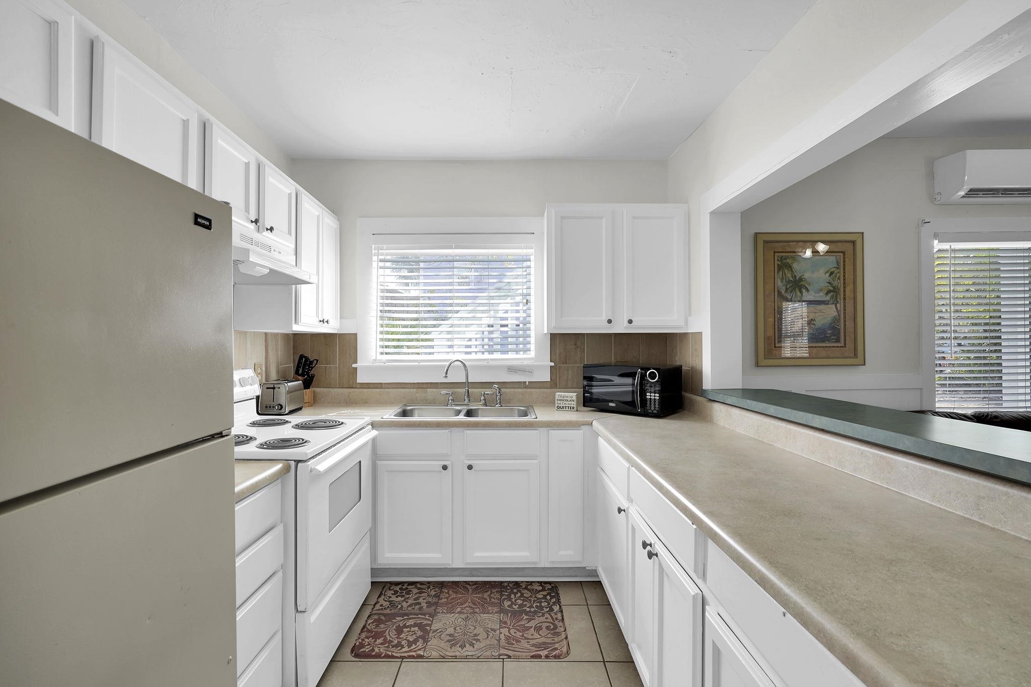 75 Cedar Street St. Augustine, FL 32084 - Photo 46 of 56 a kitchen with a sink stove top oven and cabinets