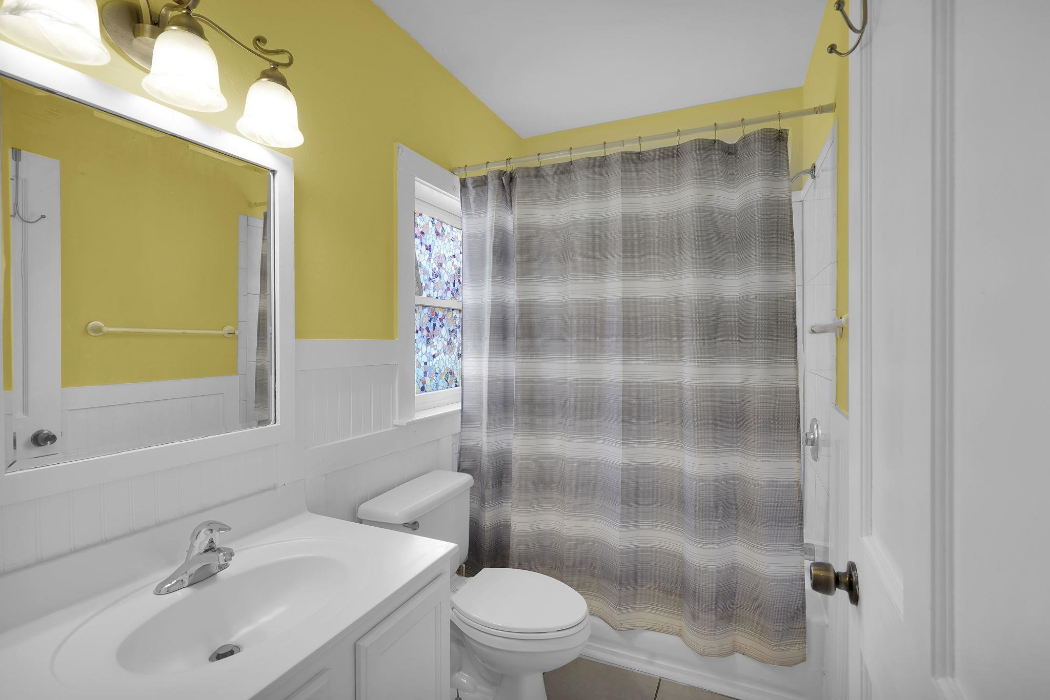 75 Cedar Street St. Augustine, FL 32084 - Photo 50 of 56 a bathroom with a shower sink vanity mirror and toilet