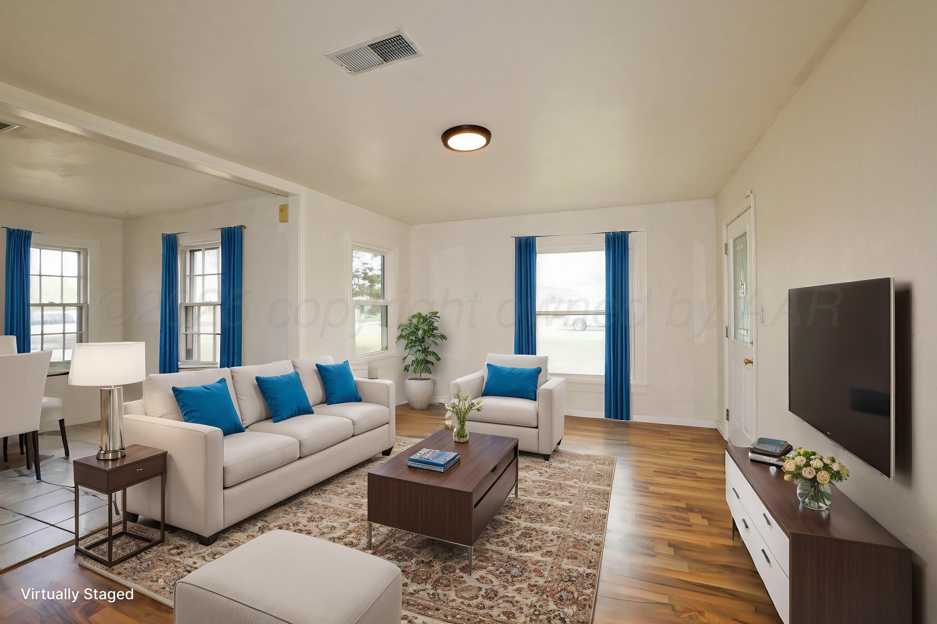 a living room with furniture and a flat screen tv