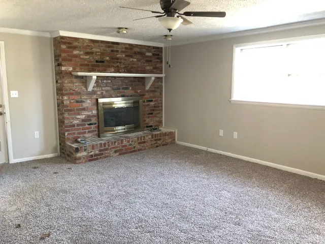 a view of an empty room with a fireplace