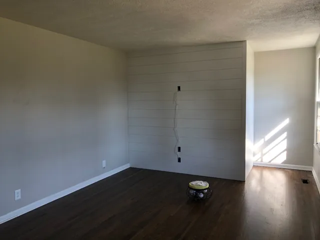 an empty room with wooden floor