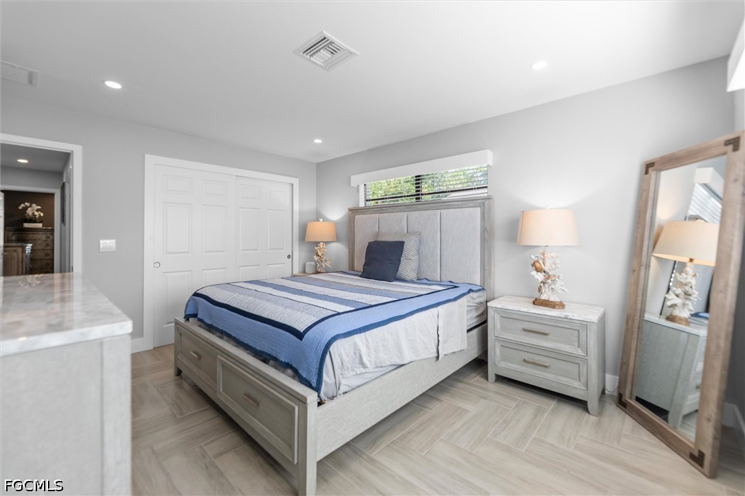 1200 Patterson Road Cape Coral, FL 33909 - Photo 18 of 42 a bedroom with a bed and a flat tv screen on the dresser