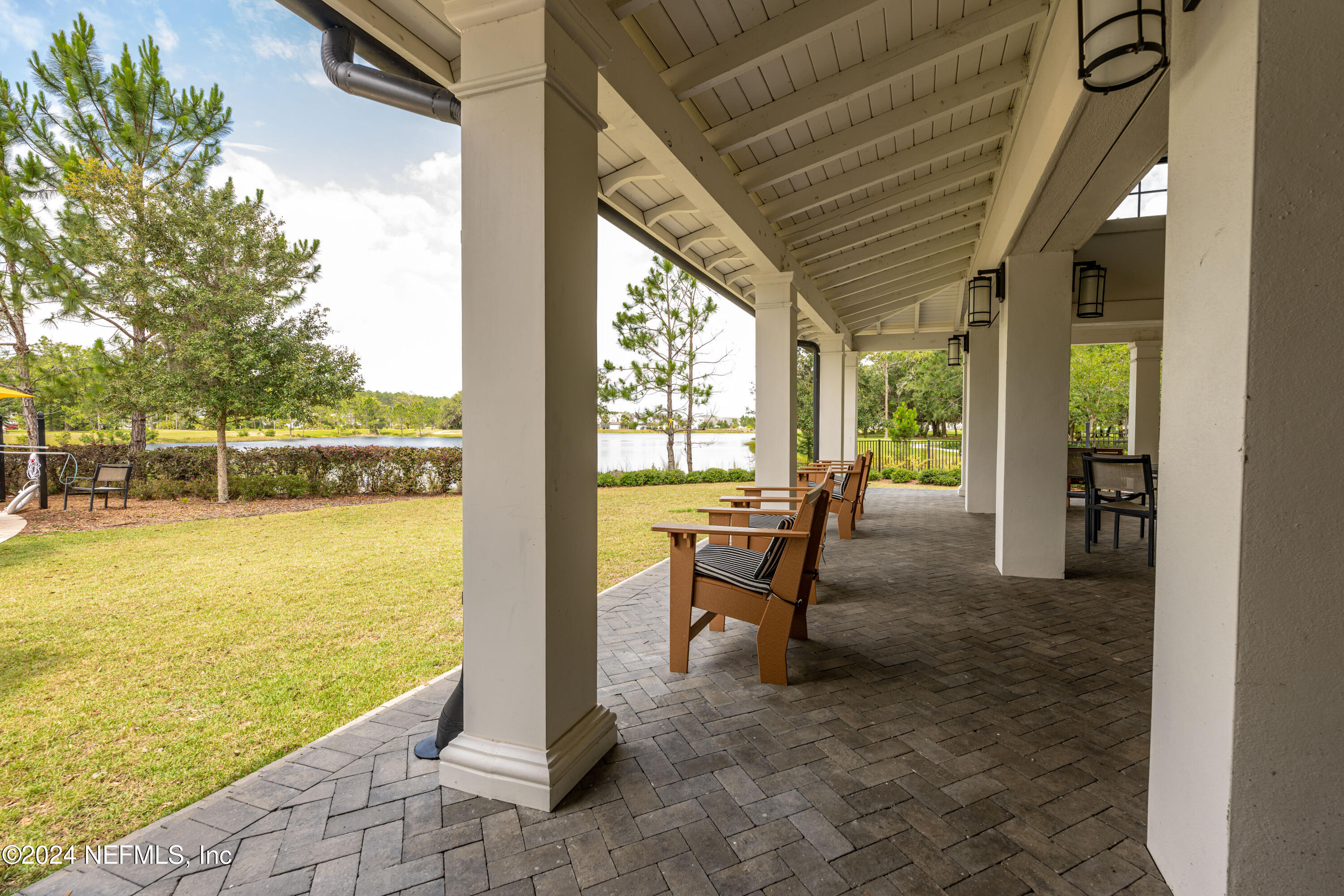 45 Bird Watch Court St. Augustine, FL 32092 - Photo 33 of 37 a view of a swimming pool with lawn chairs and floor to ceiling window