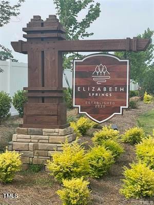 a sign that is sitting in front of a house