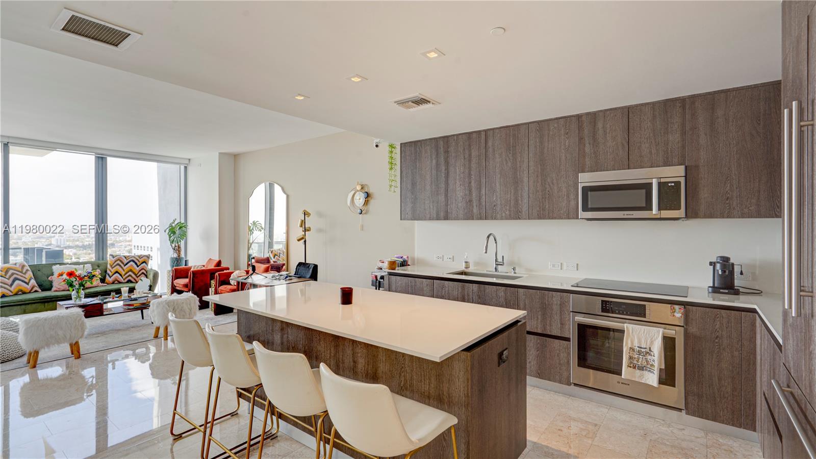 88 Southwest 7th Street, Unit 2706 Miami, FL 33130 - Photo 12 of 58 a kitchen with a sink stove and cabinets