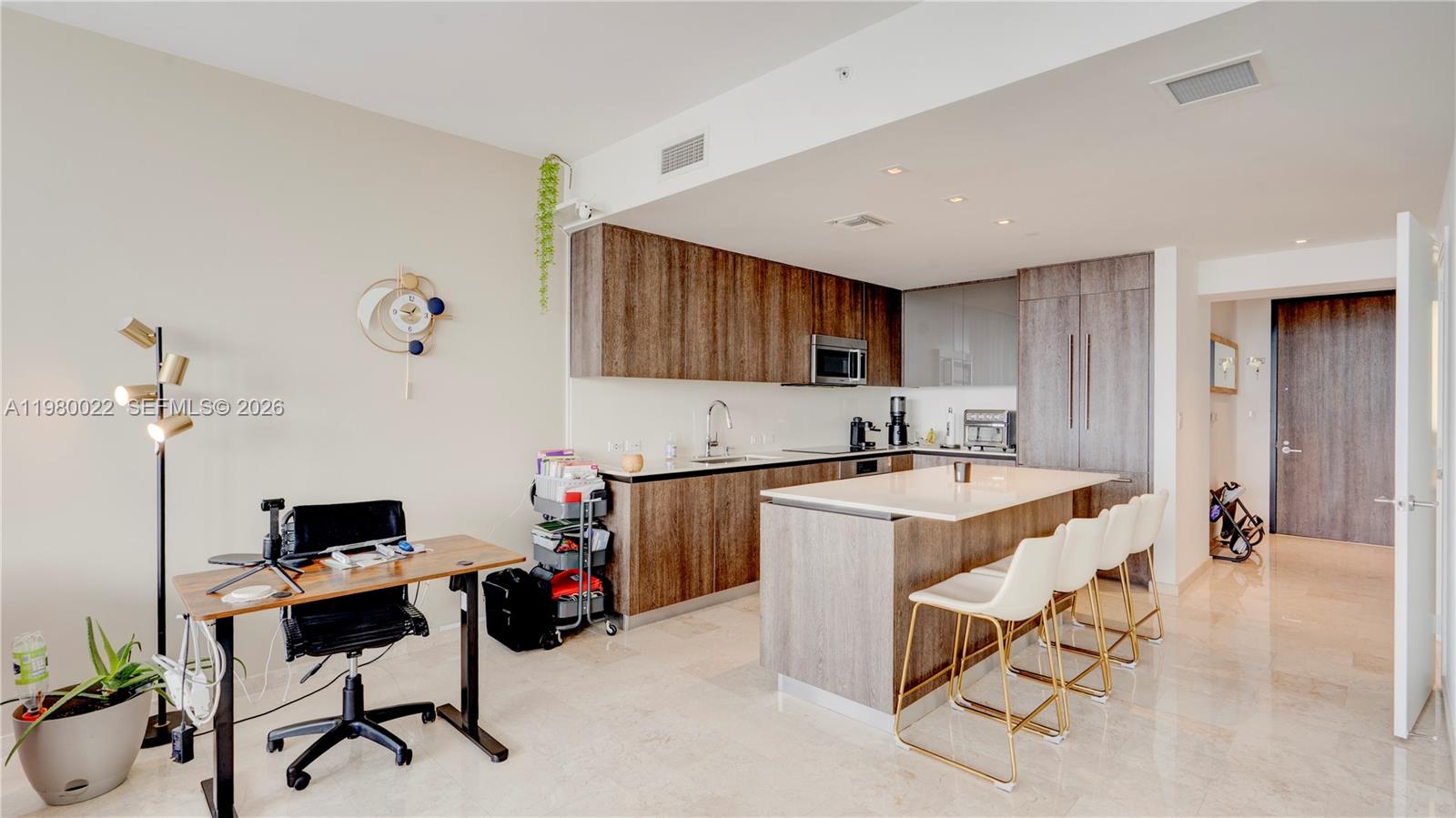88 Southwest 7th Street, Unit 2706 Miami, FL 33130 - Photo 15 of 58 a kitchen that has a sink and a stove in it