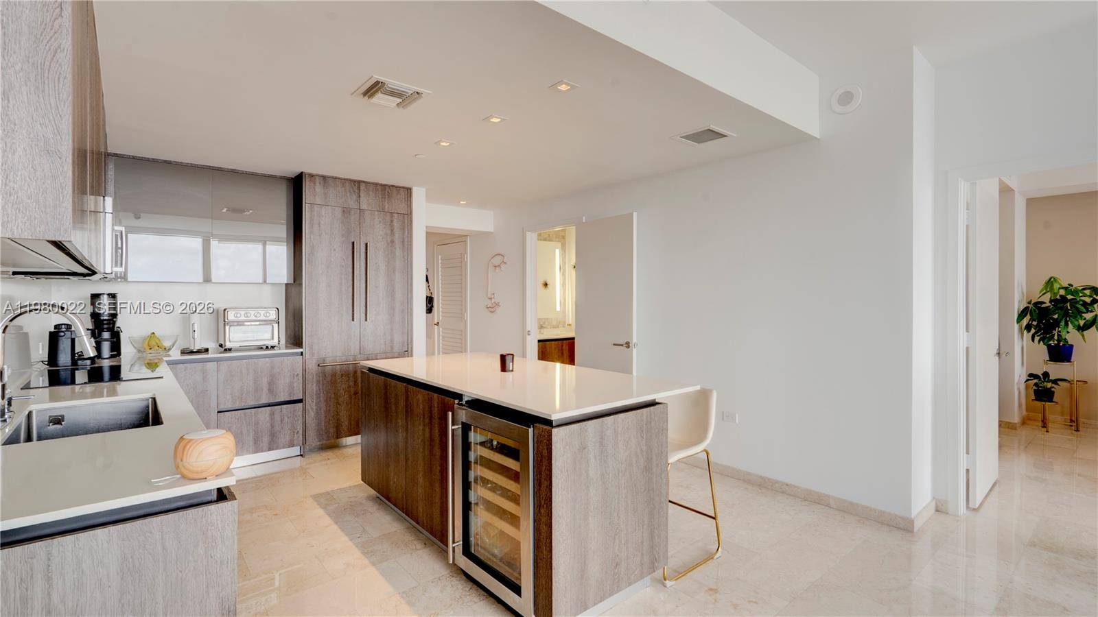 88 Southwest 7th Street, Unit 2706 Miami, FL 33130 - Photo 20 of 58 a kitchen with a stove refrigerator and a sink