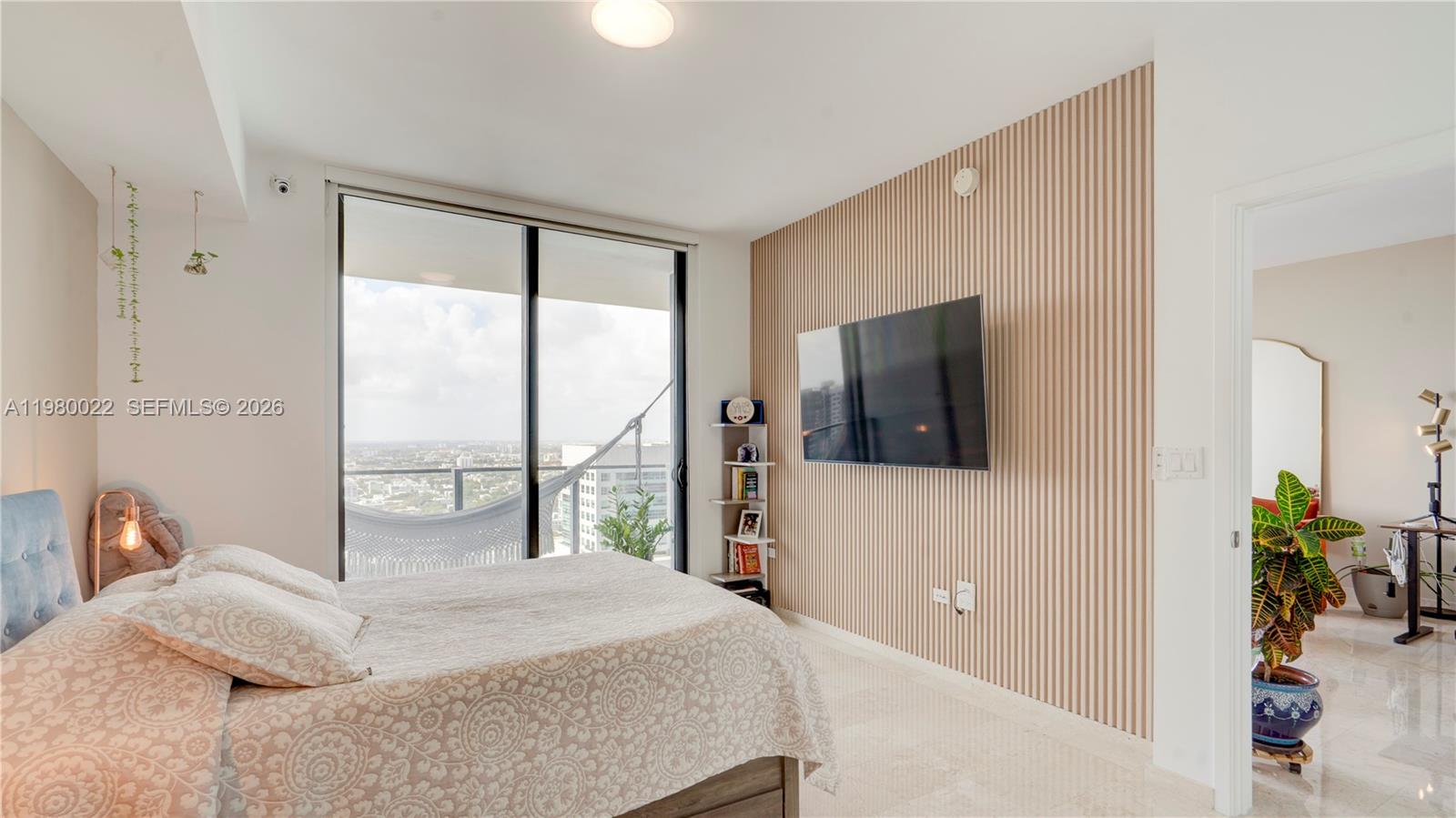 88 Southwest 7th Street, Unit 2706 Miami, FL 33130 - Photo 24 of 58 a bedroom with a large bed and a large window