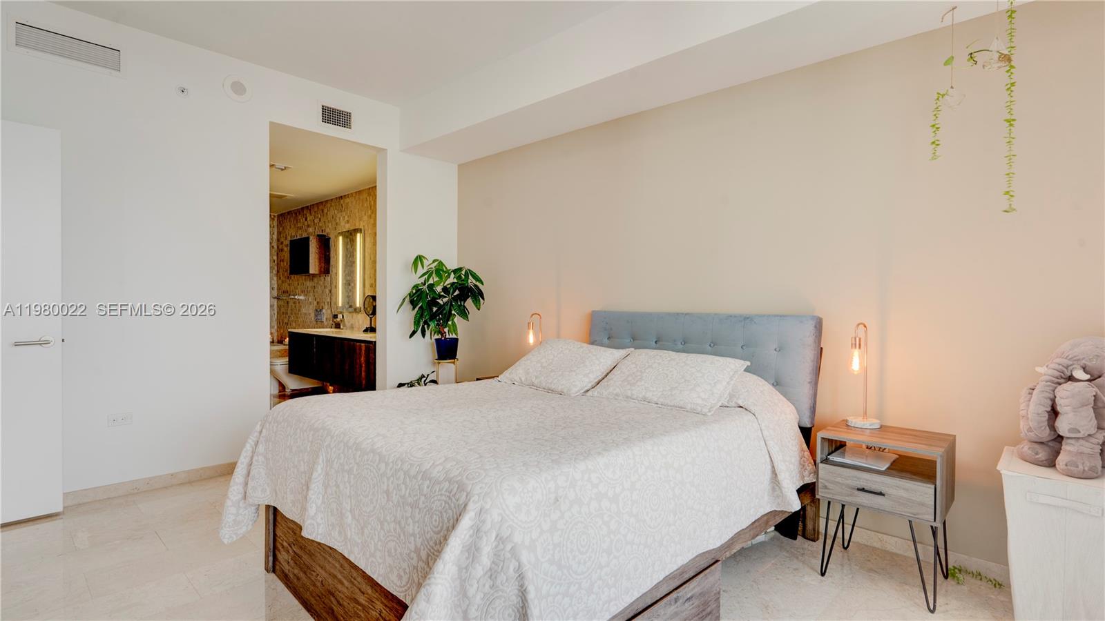 88 Southwest 7th Street, Unit 2706 Miami, FL 33130 - Photo 27 of 58 a bedroom with a bed and a table in it