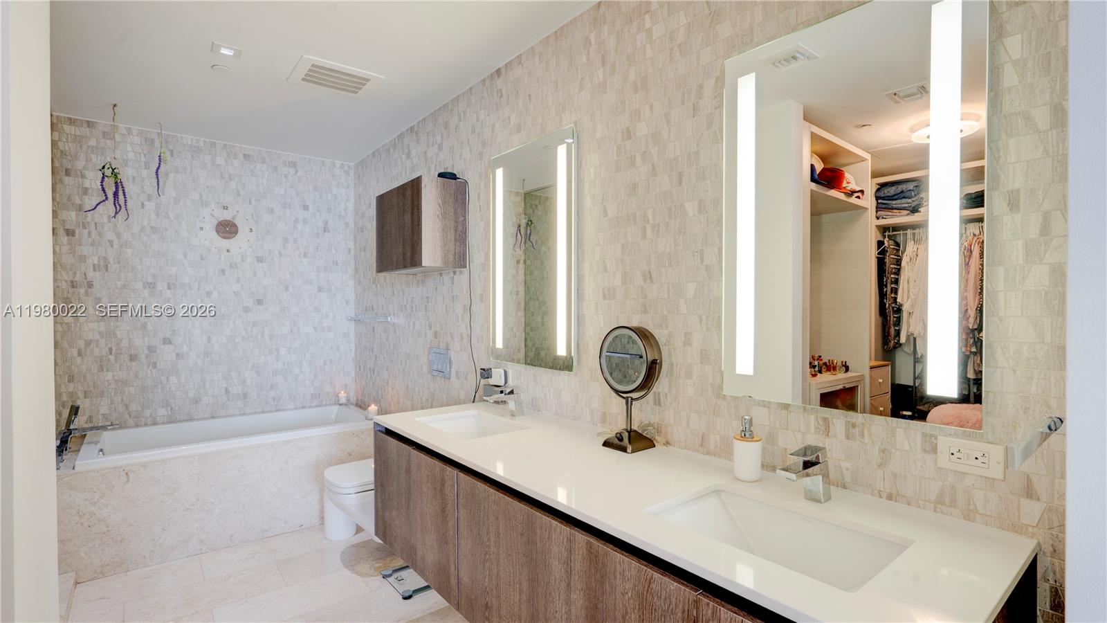 88 Southwest 7th Street, Unit 2706 Miami, FL 33130 - Photo 28 of 58 a bathroom with a sink and a mirror