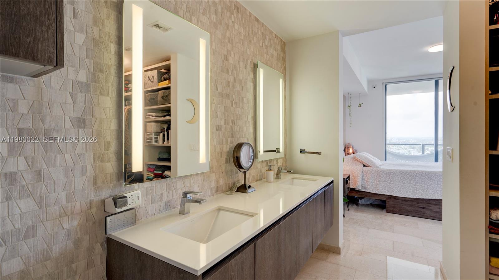 88 Southwest 7th Street, Unit 2706 Miami, FL 33130 - Photo 29 of 58 a bathroom with a sink and a mirror