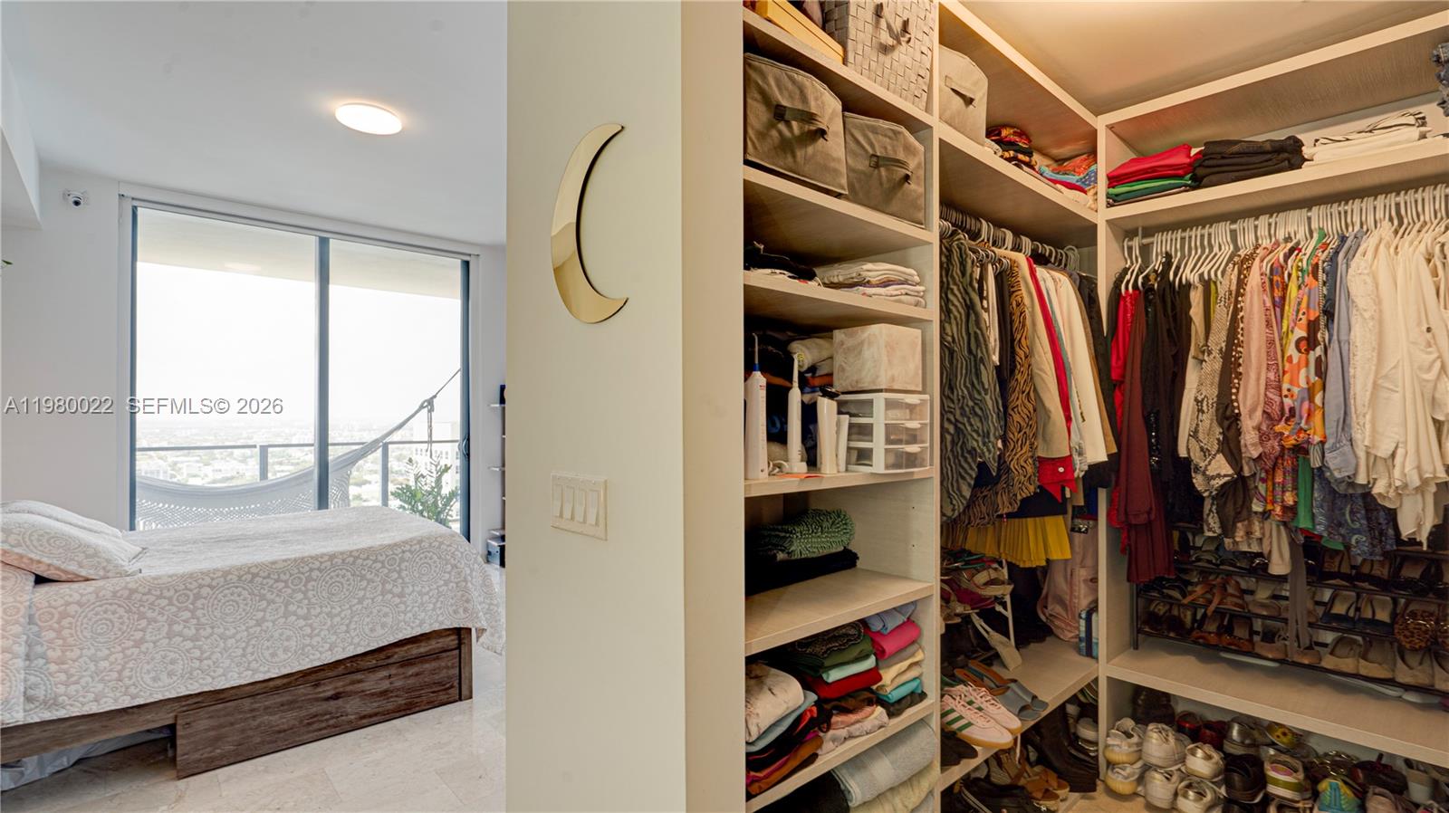 88 Southwest 7th Street, Unit 2706 Miami, FL 33130 - Photo 30 of 58 a view of walk in closet with clothes and shoes