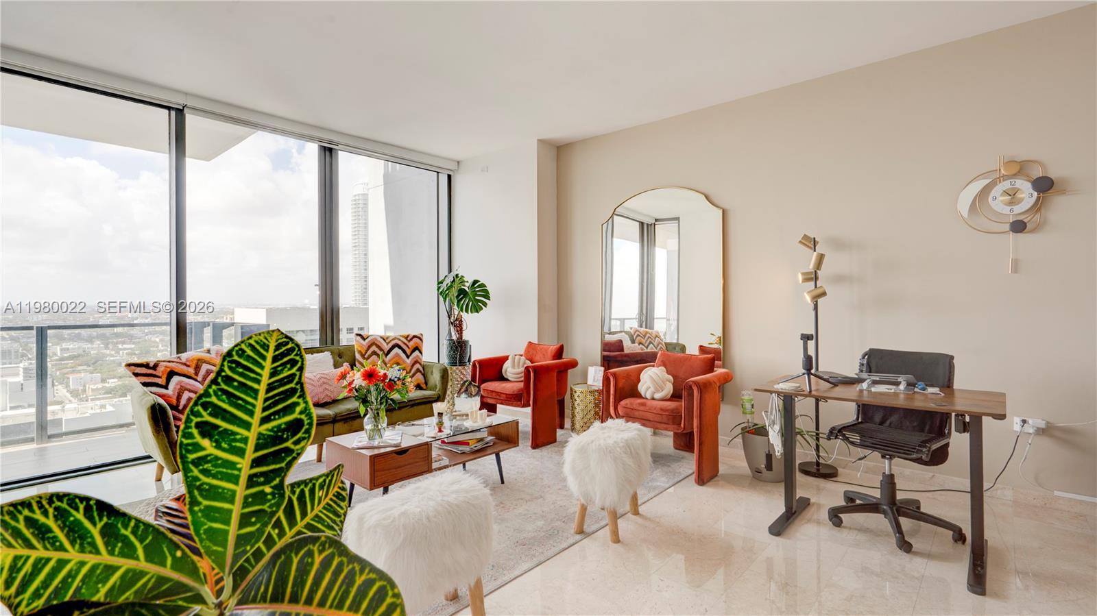 88 Southwest 7th Street, Unit 2706 Miami, FL 33130 - Photo 3 of 58 a living room with patio furniture and floor to ceiling windows