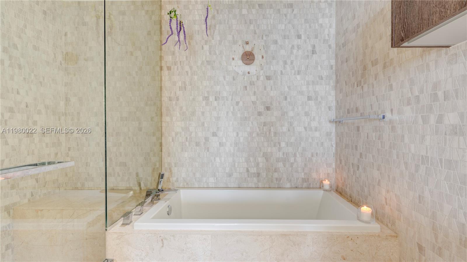 88 Southwest 7th Street, Unit 2706 Miami, FL 33130 - Photo 31 of 58 a bathroom with a bathtub and shower