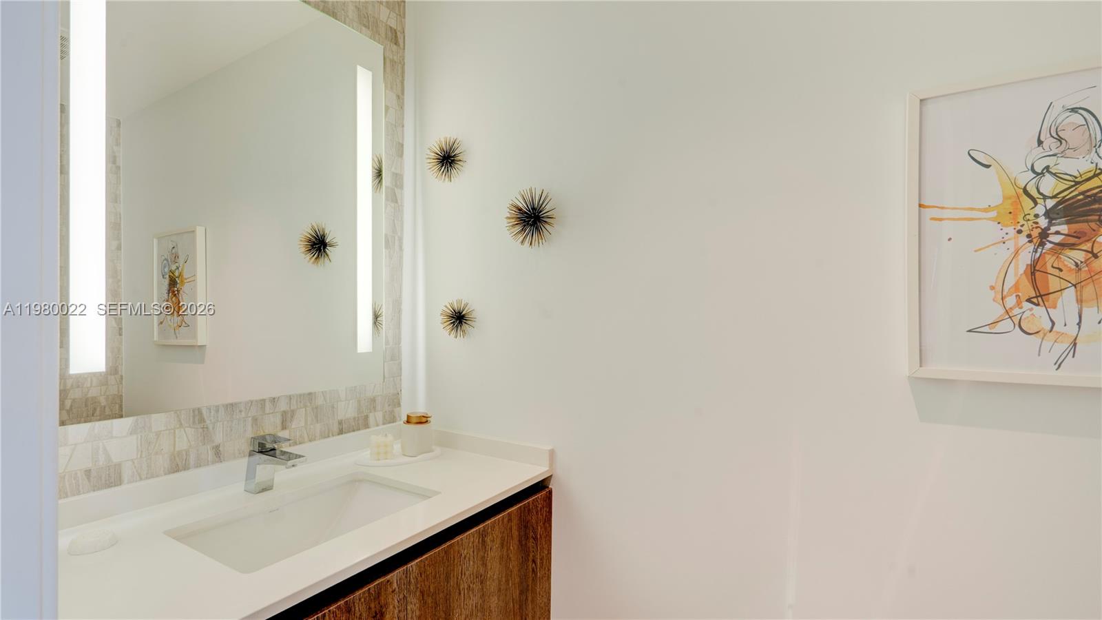 88 Southwest 7th Street, Unit 2706 Miami, FL 33130 - Photo 40 of 58 a bathroom with a sink and a mirror