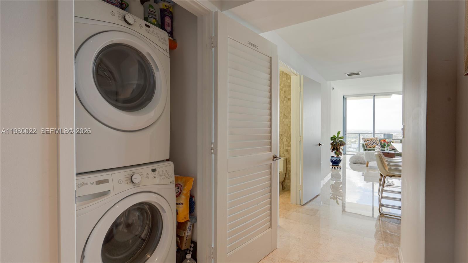 88 Southwest 7th Street, Unit 2706 Miami, FL 33130 - Photo 41 of 58 a view of a hallway with washer and dryer