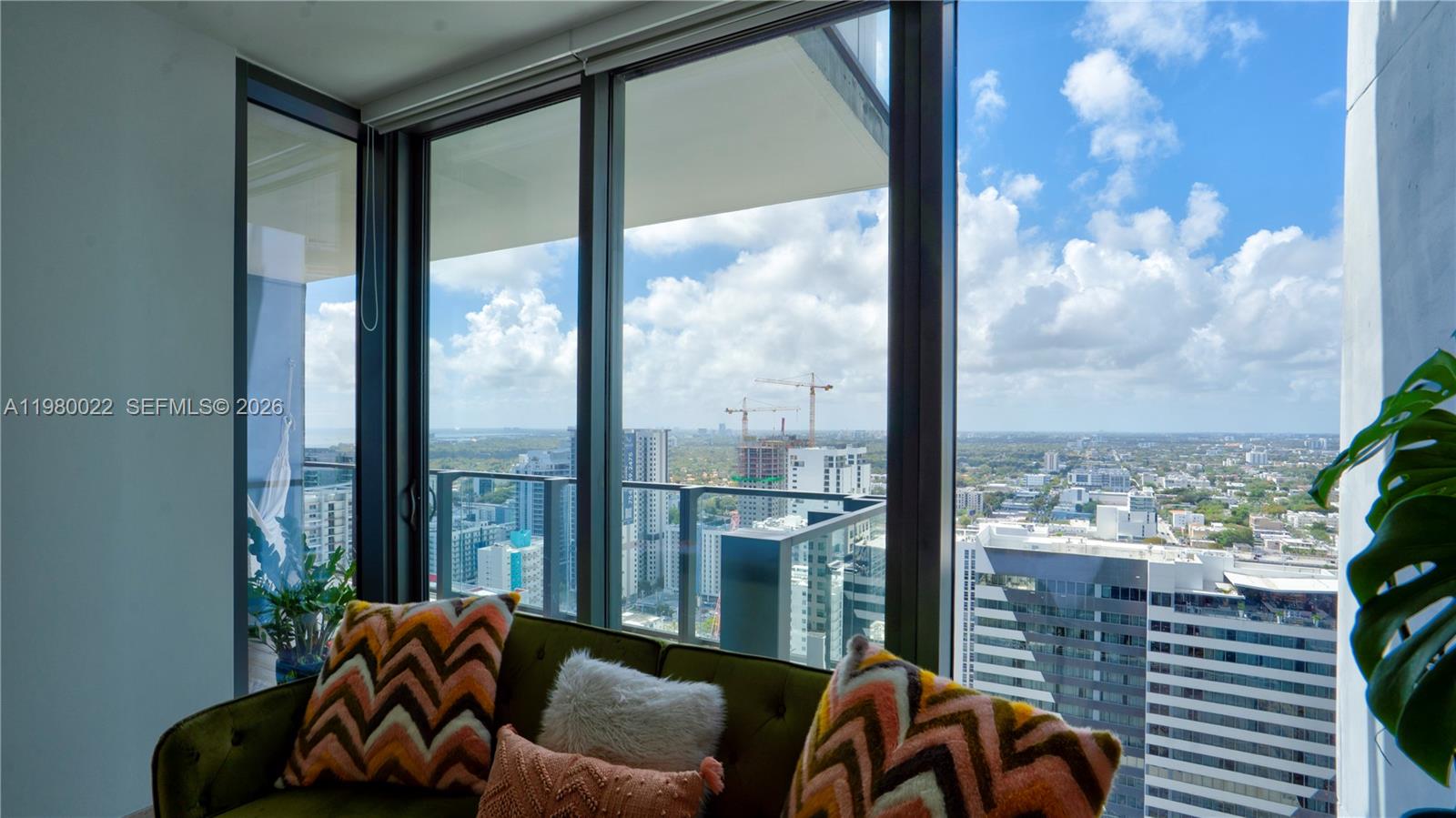 88 Southwest 7th Street, Unit 2706 Miami, FL 33130 - Photo 42 of 58 a living room filled with furniture and a large window