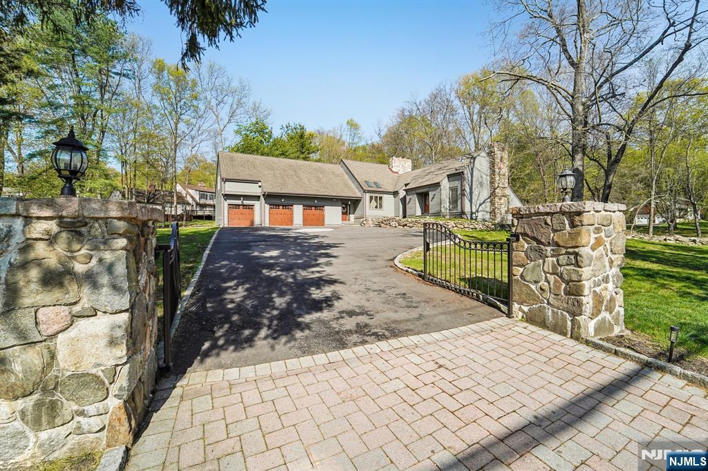 11 Carlough Road Upper Saddle River, NJ 07458 - Photo 2 of 41 a view of a backyard with wooden fence