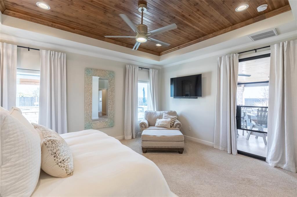 169 Pne Spgs Cove Tuscola, TX 79562 - Photo 13 of 40 a spacious bedroom with a bed and a flat screen tv