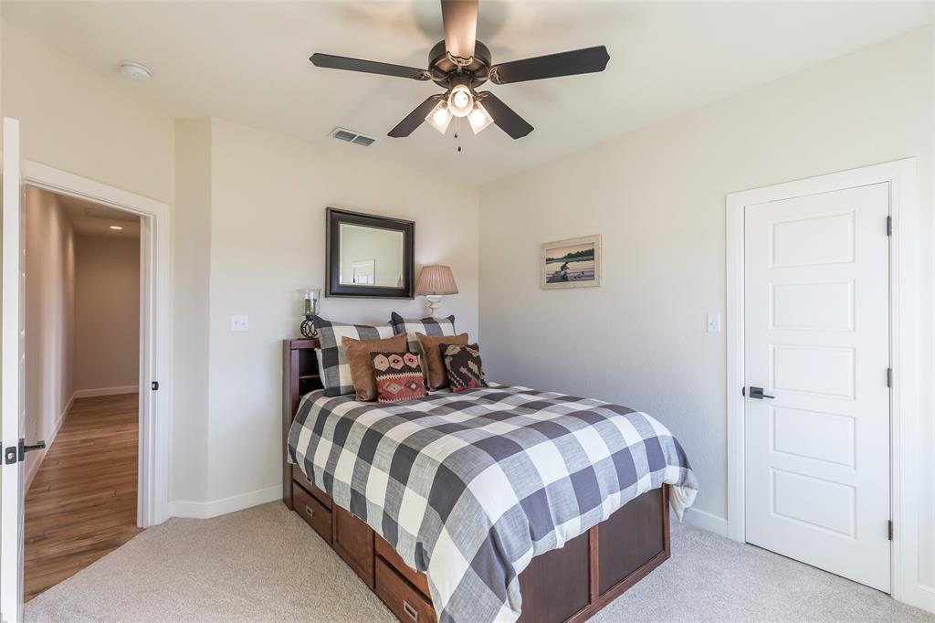 169 Pne Spgs Cove Tuscola, TX 79562 - Photo 18 of 40 a bedroom with a bed and a chandelier