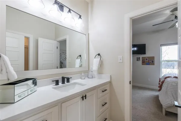 a en suite bathroom with double sink and a mirror