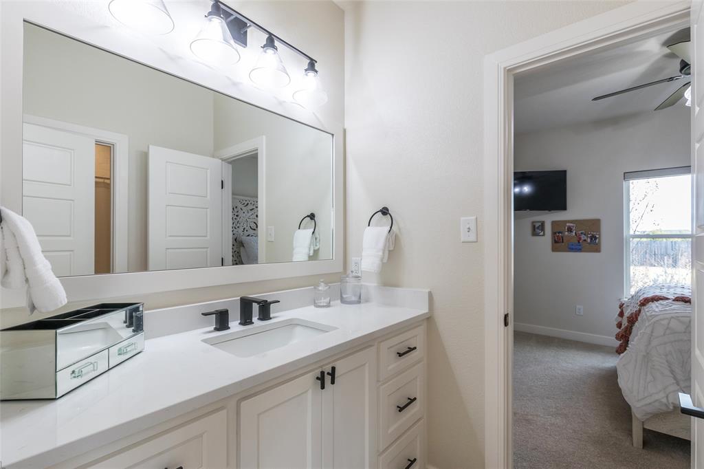 169 Pne Spgs Cove Tuscola, TX 79562 - Photo 23 of 40 a en suite bathroom with double sink and a mirror