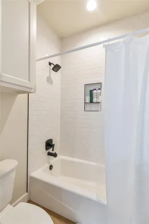 a bathroom with a toilet a sink and a bathtub