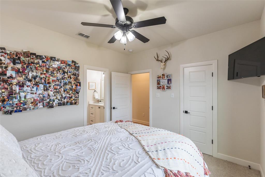 169 Pne Spgs Cove Tuscola, TX 79562 - Photo 26 of 40 a bedroom with a bed and a chandelier