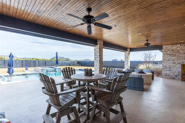 a view of a patio with a dining table and chairs