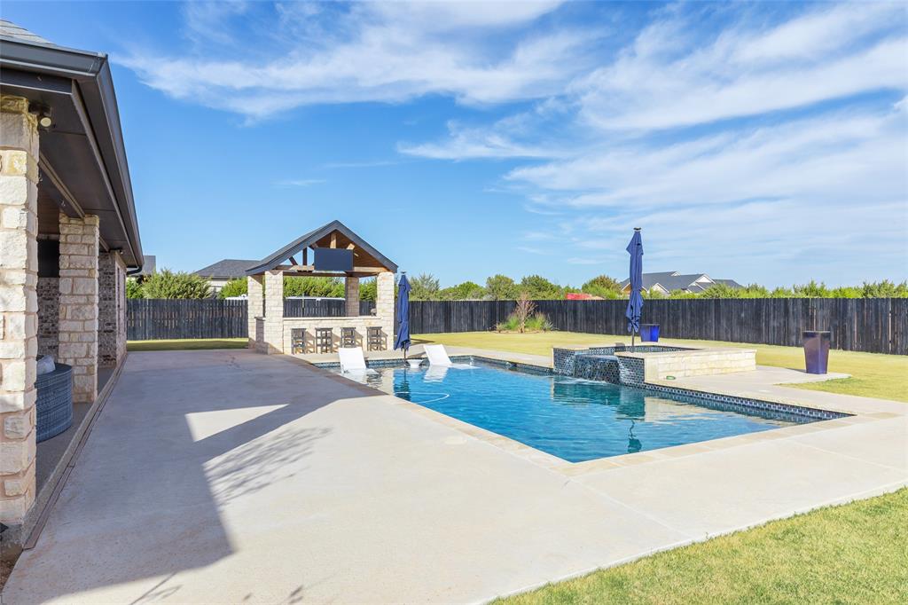 169 Pne Spgs Cove Tuscola, TX 79562 - Photo 31 of 40 a view of a swimming pool with an outdoor seating