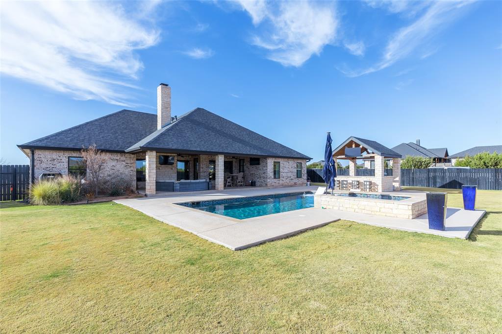 169 Pne Spgs Cove Tuscola, TX 79562 - Photo 34 of 40 a house with swimming pool in front of it