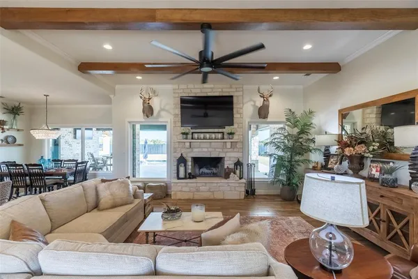 a living room with furniture a fireplace and a flat screen tv