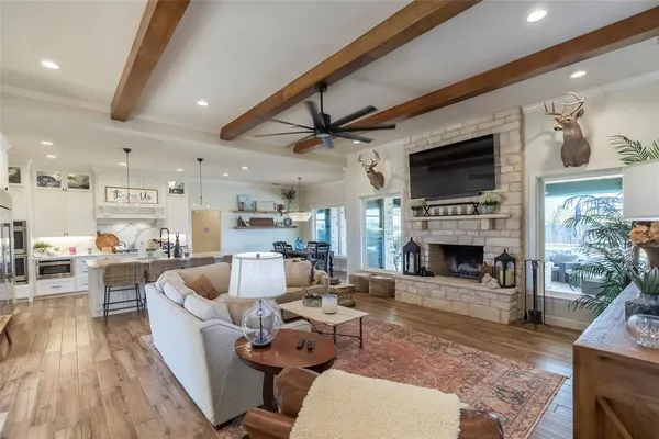 a living room with furniture a fireplace a flat screen tv and potted plant
