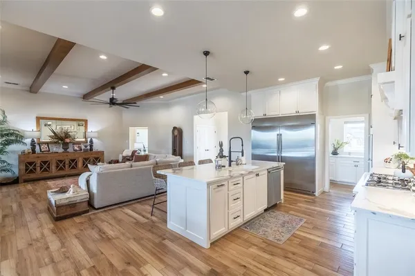 a kitchen with stainless steel appliances kitchen island granite countertop a stove and a refrigerator