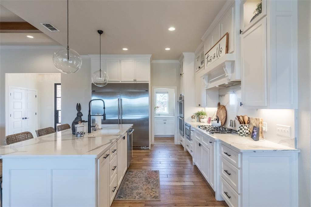 169 Pne Spgs Cove Tuscola, TX 79562 - Photo 7 of 40 a kitchen with stainless steel appliances a sink stove and cabinets