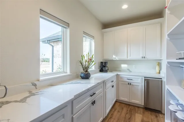 a kitchen with a sink cabinets and window