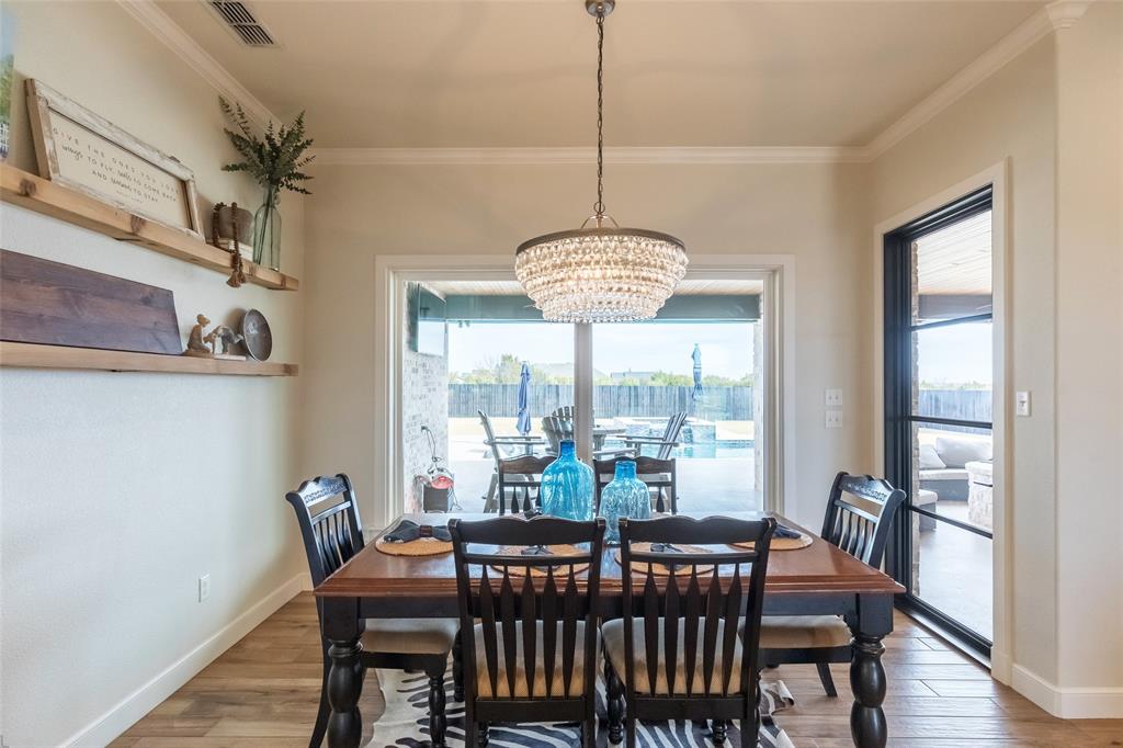 169 Pne Spgs Cove Tuscola, TX 79562 - Photo 10 of 40 a view of a dining room with furniture window and wooden floor