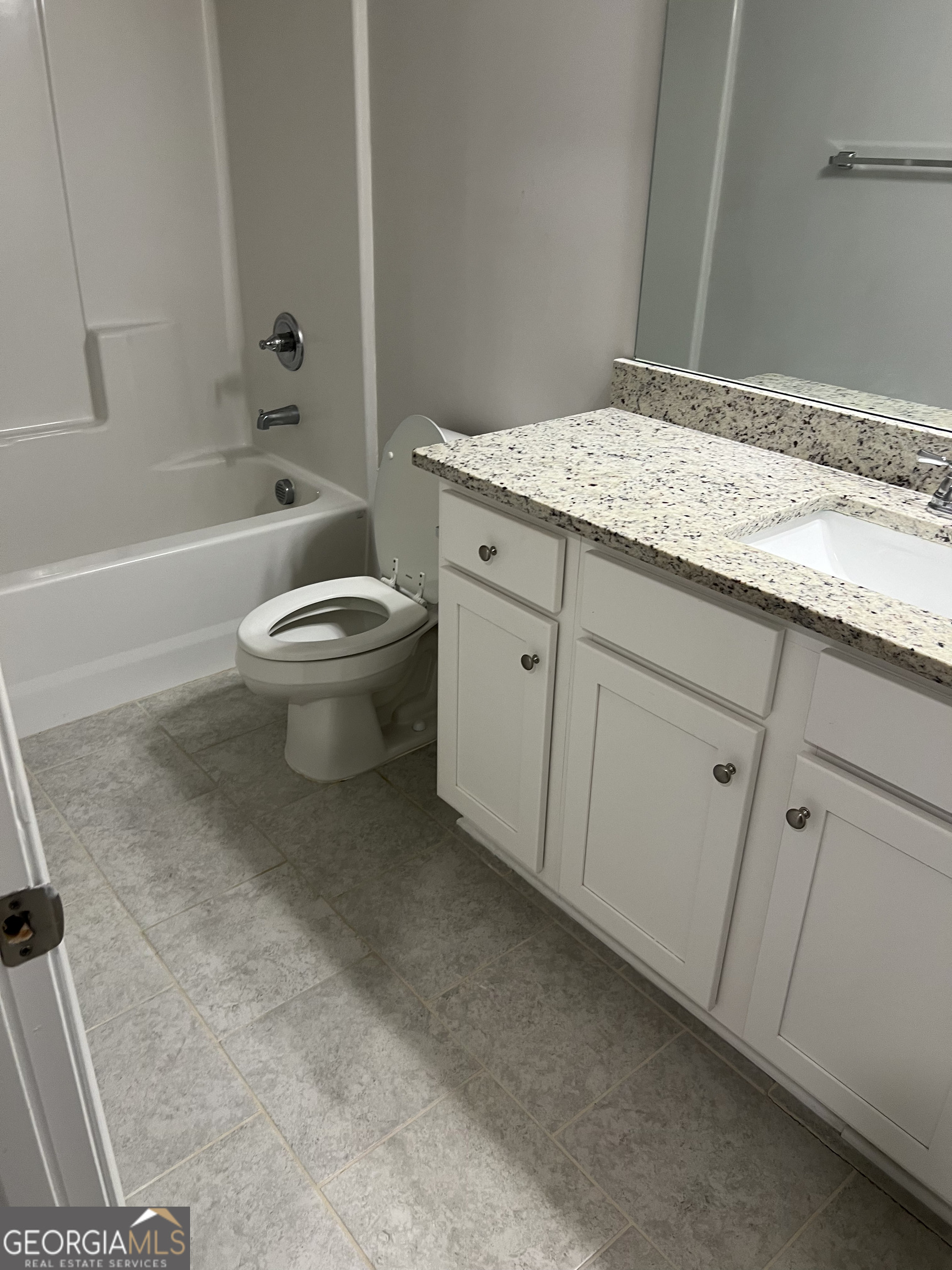 932 Exposition Pte Marietta, GA 30067 - Photo 4 of 8 a bathroom with a granite countertop sink a toilet and bathtub