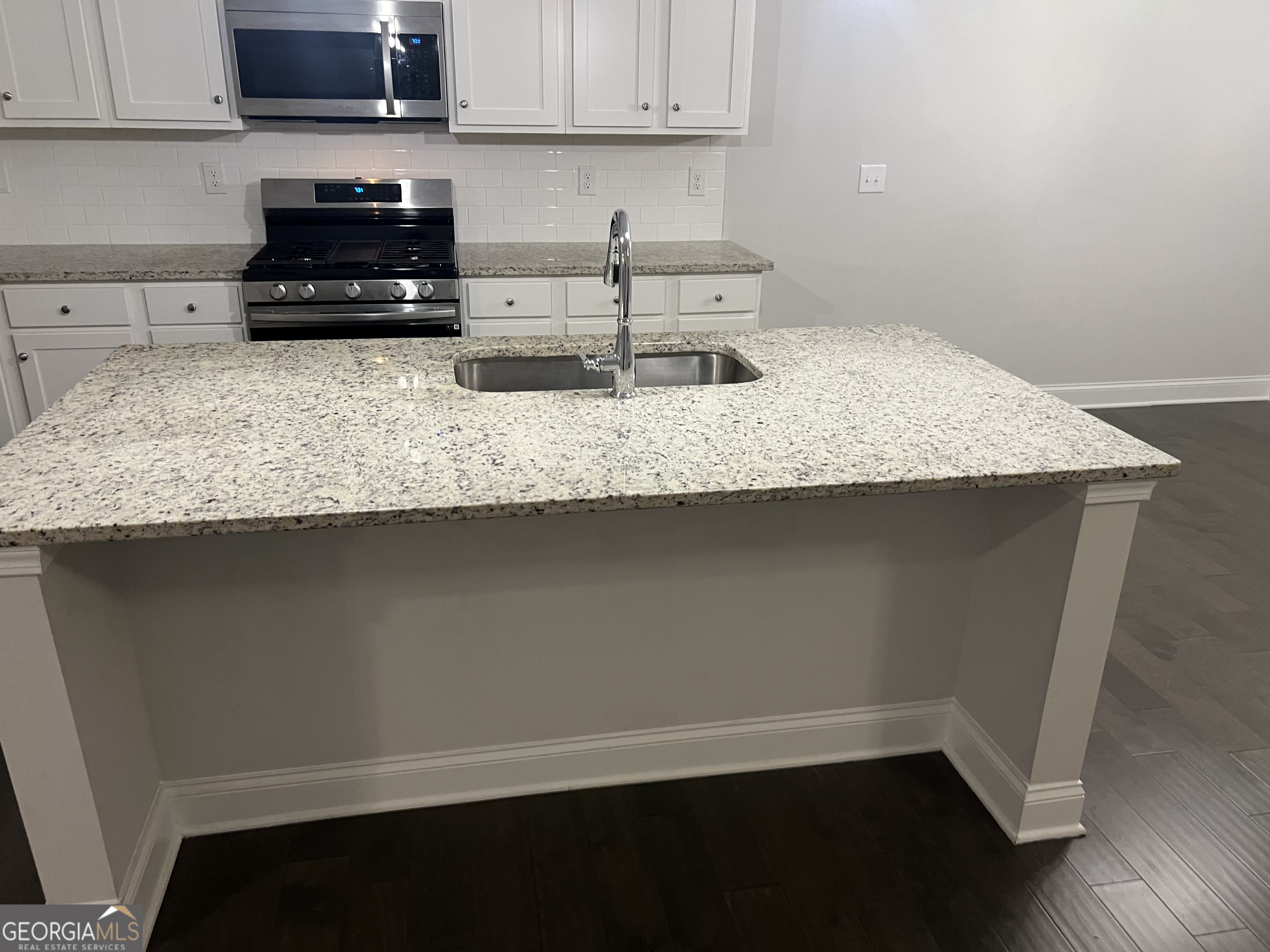 932 Exposition Pte Marietta, GA 30067 - Photo 7 of 8 a kitchen with granite countertop a sink a stove and cabinets